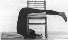 Ardha Halasana, with blankets and a chair